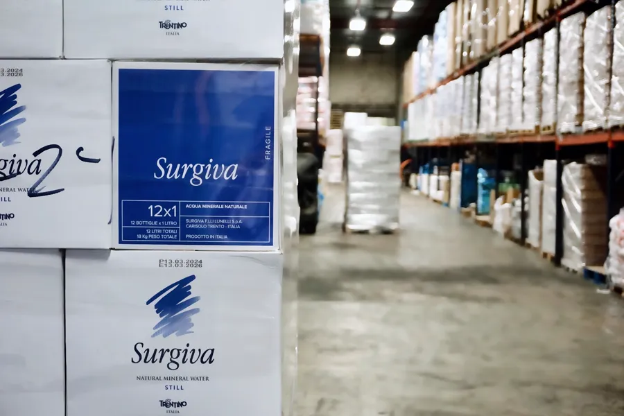 Cases of imported mineral water stacked in the warehouse
